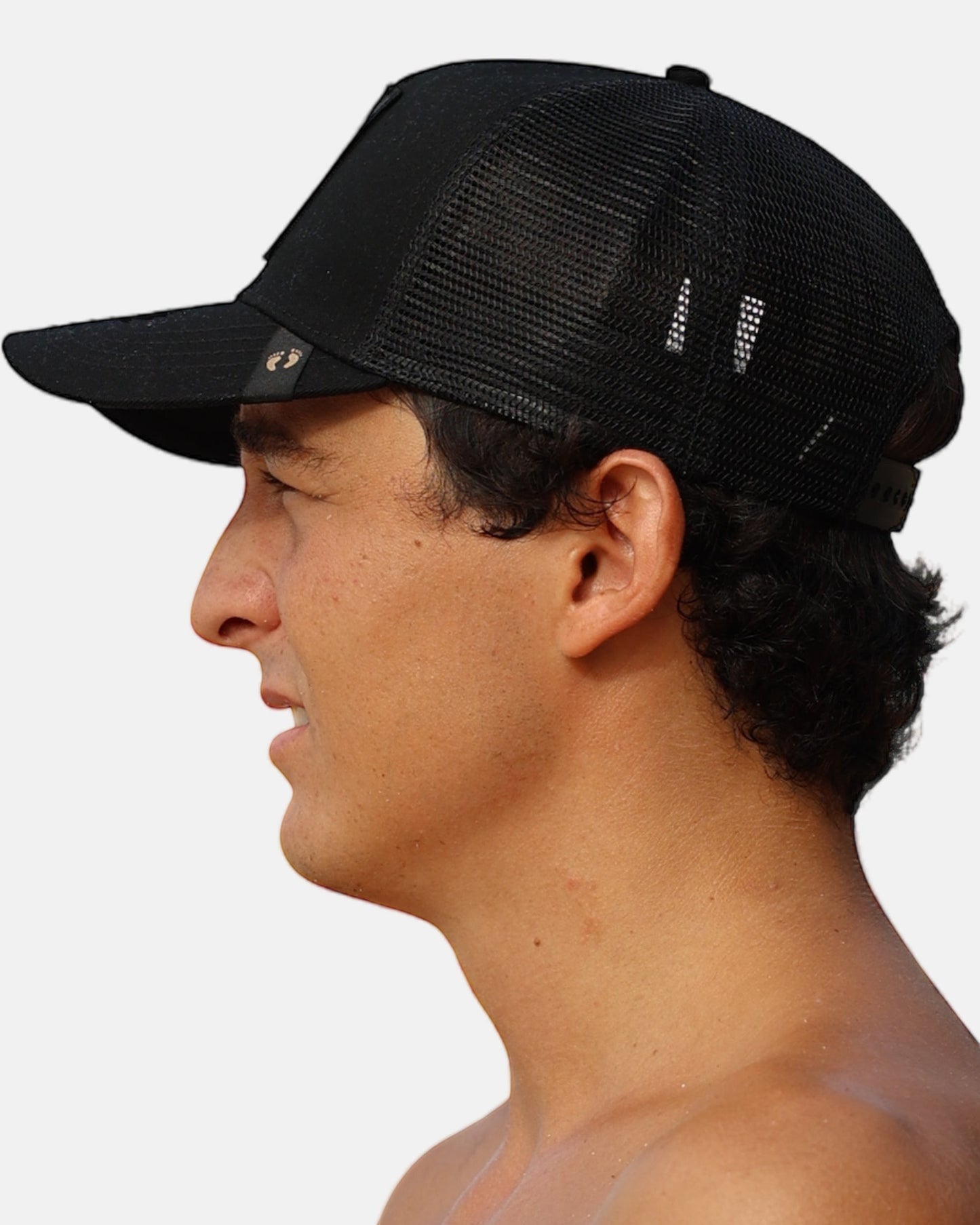 Hang Ten black trucker cap with mesh back and embroidered logo patch. Made from cotton and polyester with adjustable snapback.