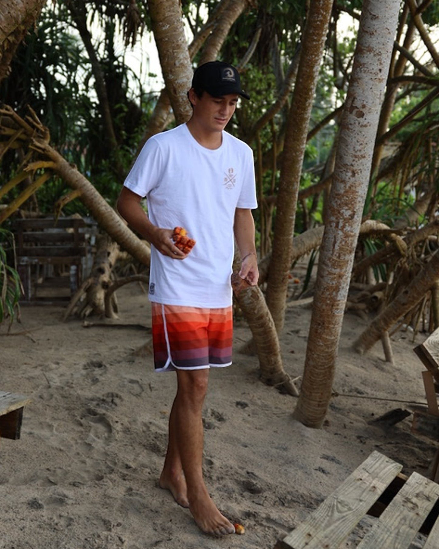 Hang Ten black trucker cap with adjustable snapback and embroidered logo patch on front. Cotton and polyester blend.