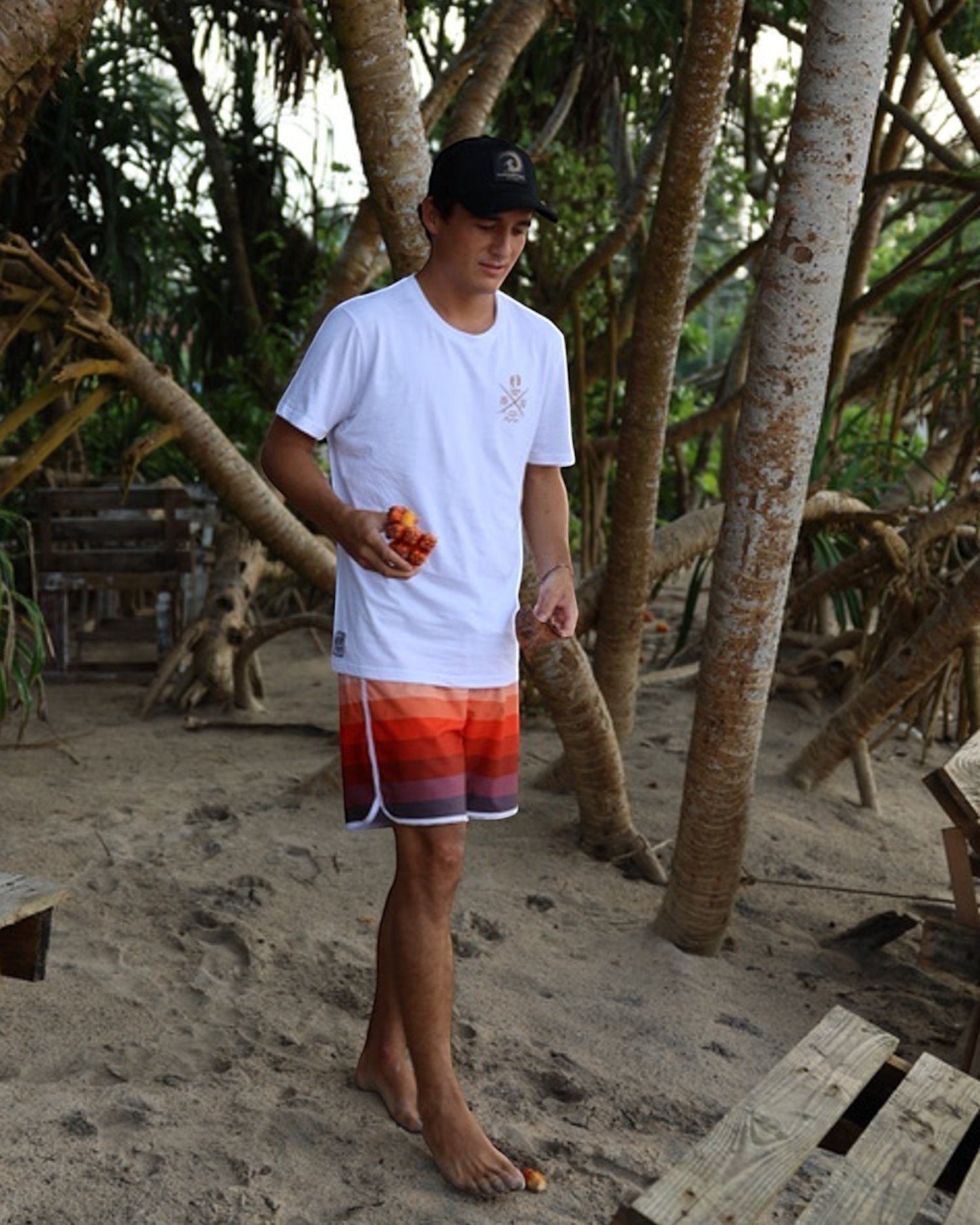 Hang Ten black trucker cap with adjustable snapback and embroidered logo patch on front. Cotton and polyester blend.